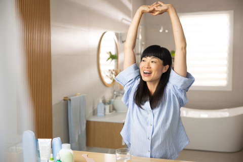 Woman Stretching and Smiling_Adjusting to New Routines